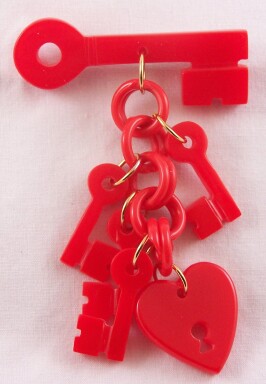 AB3 red bakelite heart/key pin